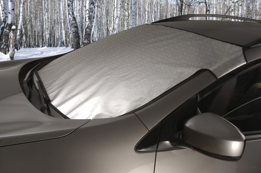 Custom SnowShade covering a car windshield in a winter setting